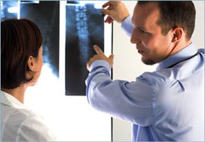 Dr. Silva pointing at spine x-ray